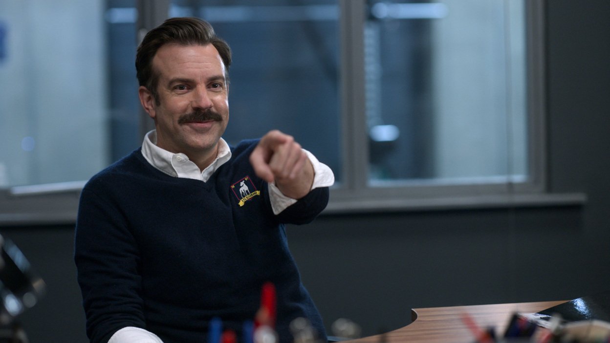 Jason Sudeikis as Ted Lasso points ahead. 