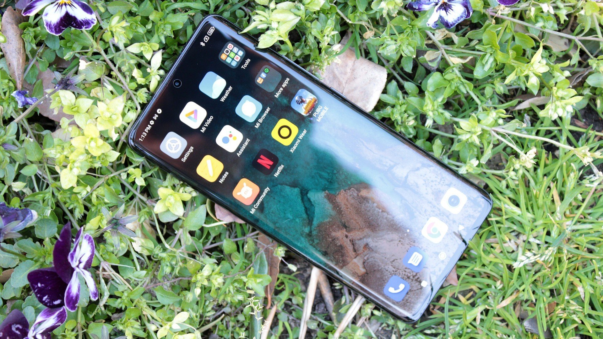 A photo of the Xiaomi 12 Pro lying on the grass.