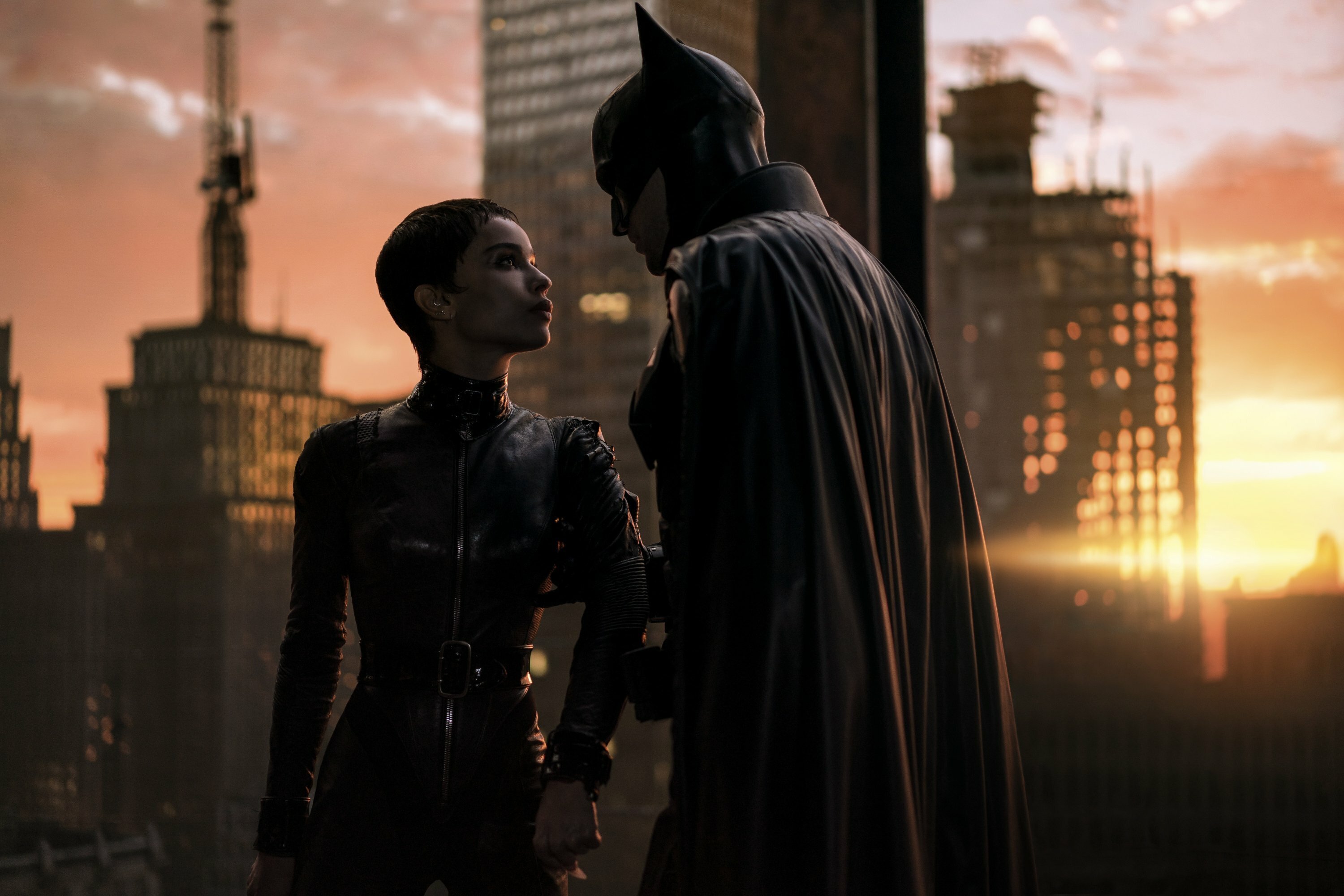 Zoë Kravitz and Robert Pattinson stand on a rooftop in The Batman