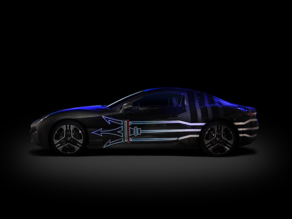 A sports car with a trident painted on its side.