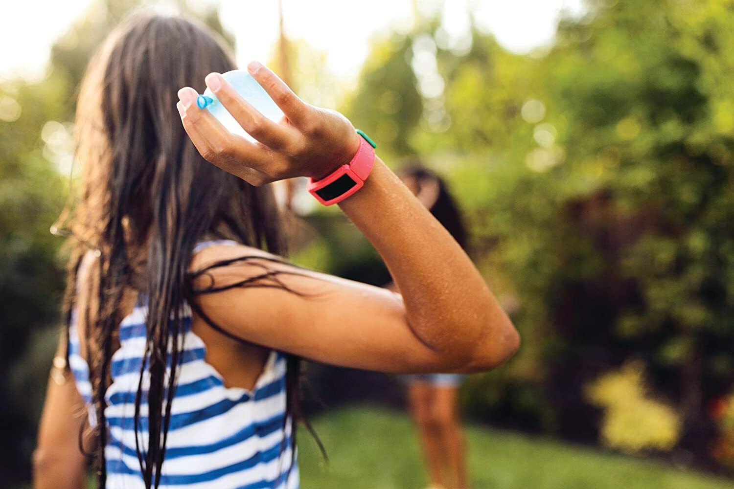 Child wearing red fitness tracker