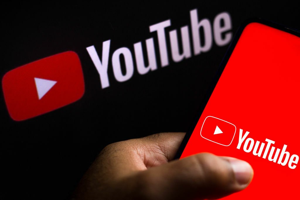 The YouTube logo displayed on a smartphone.