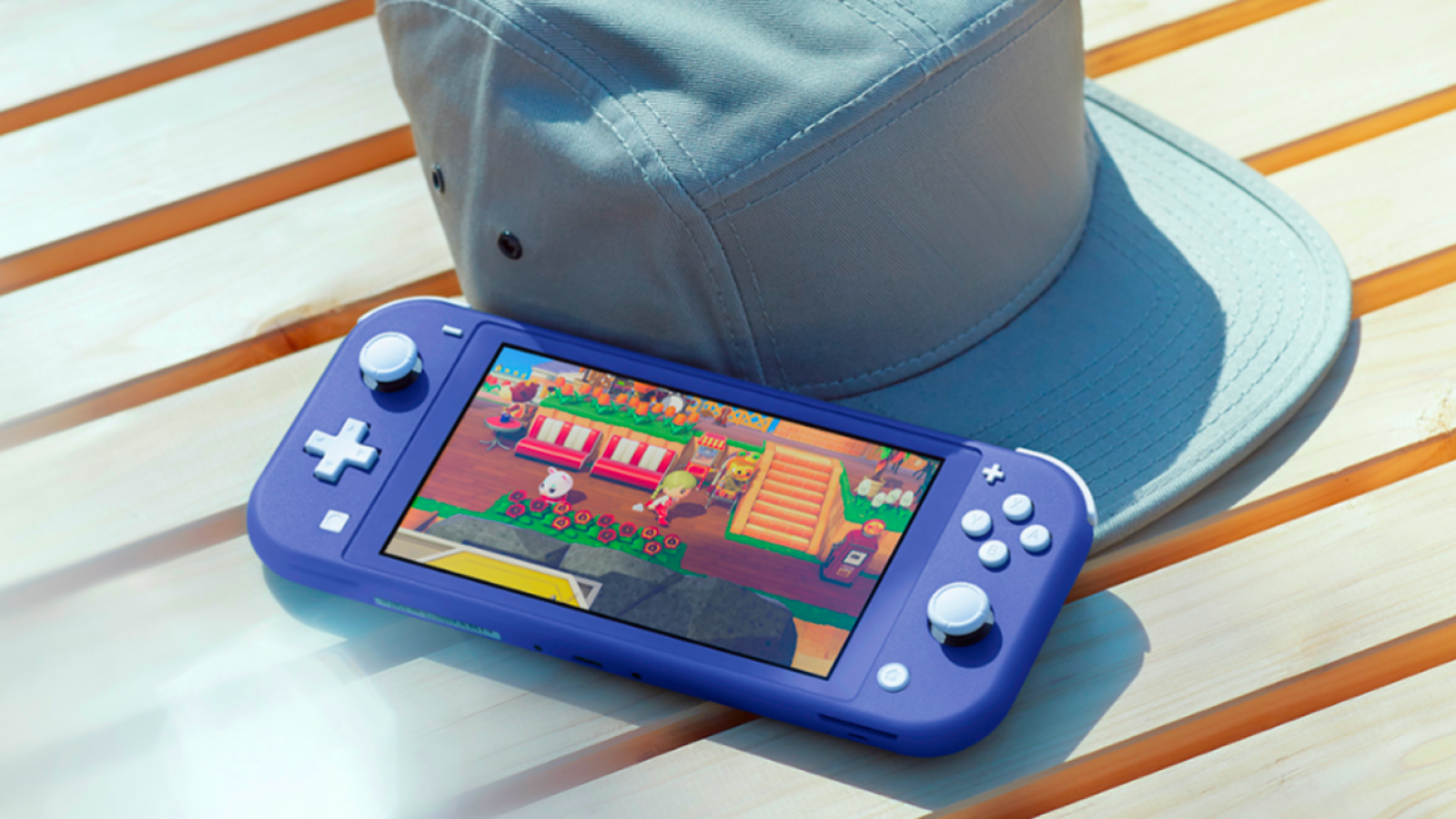 a blue nintendo switch lite resting against a cap