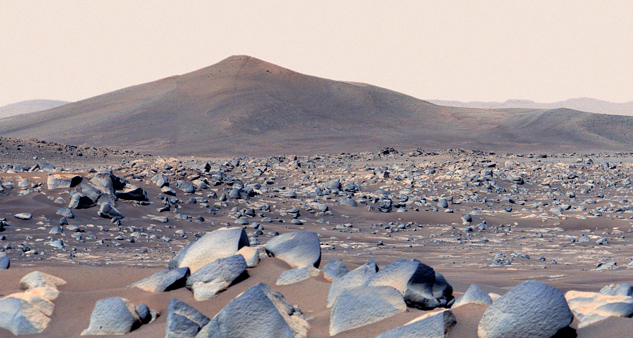 A photo of a rocky, dusty landscape on the surface of Mars.