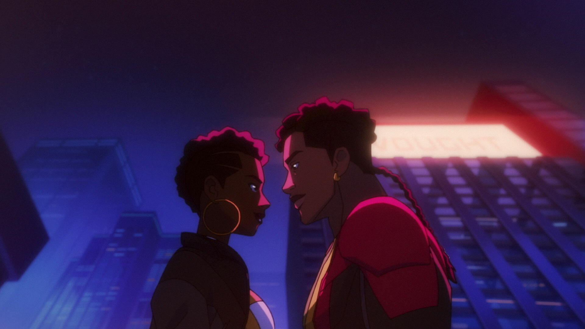 A man and a woman stand facing each other, as if they're about to kiss. The low-angled shot shows us that it's nighttime and they're standing in some kind of city setting.