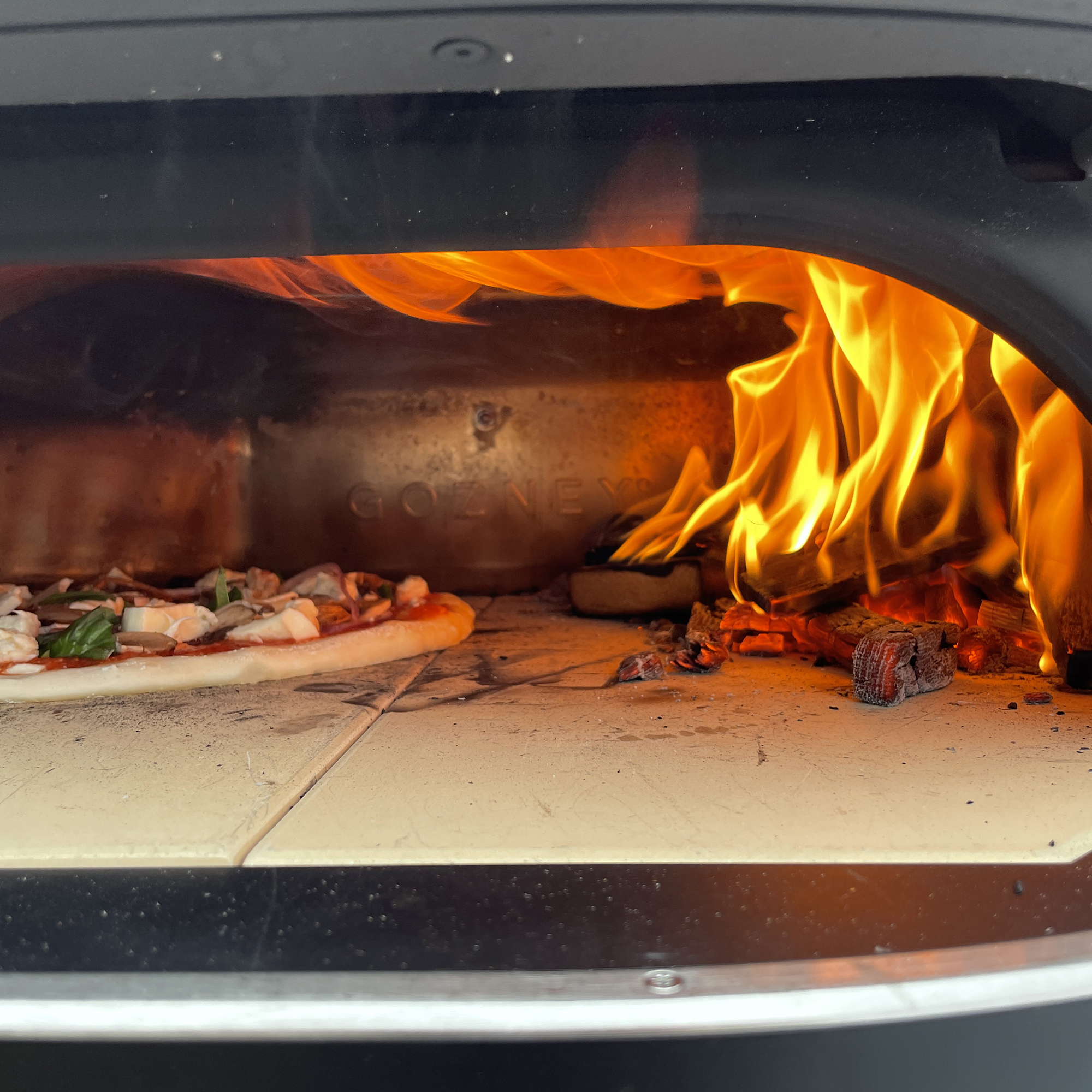 pizza inside oven with rolling flame
