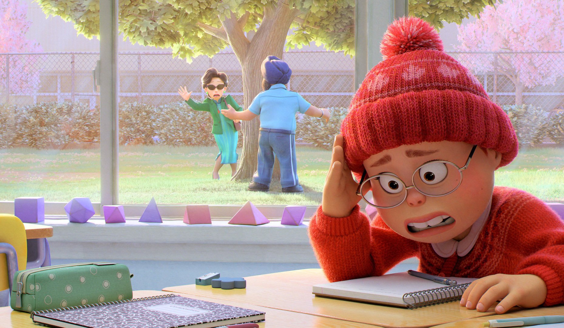 An animated teen girl cringes in a classroom while her mother waves from outside, dodging a security guard; a still from "Turning Red."