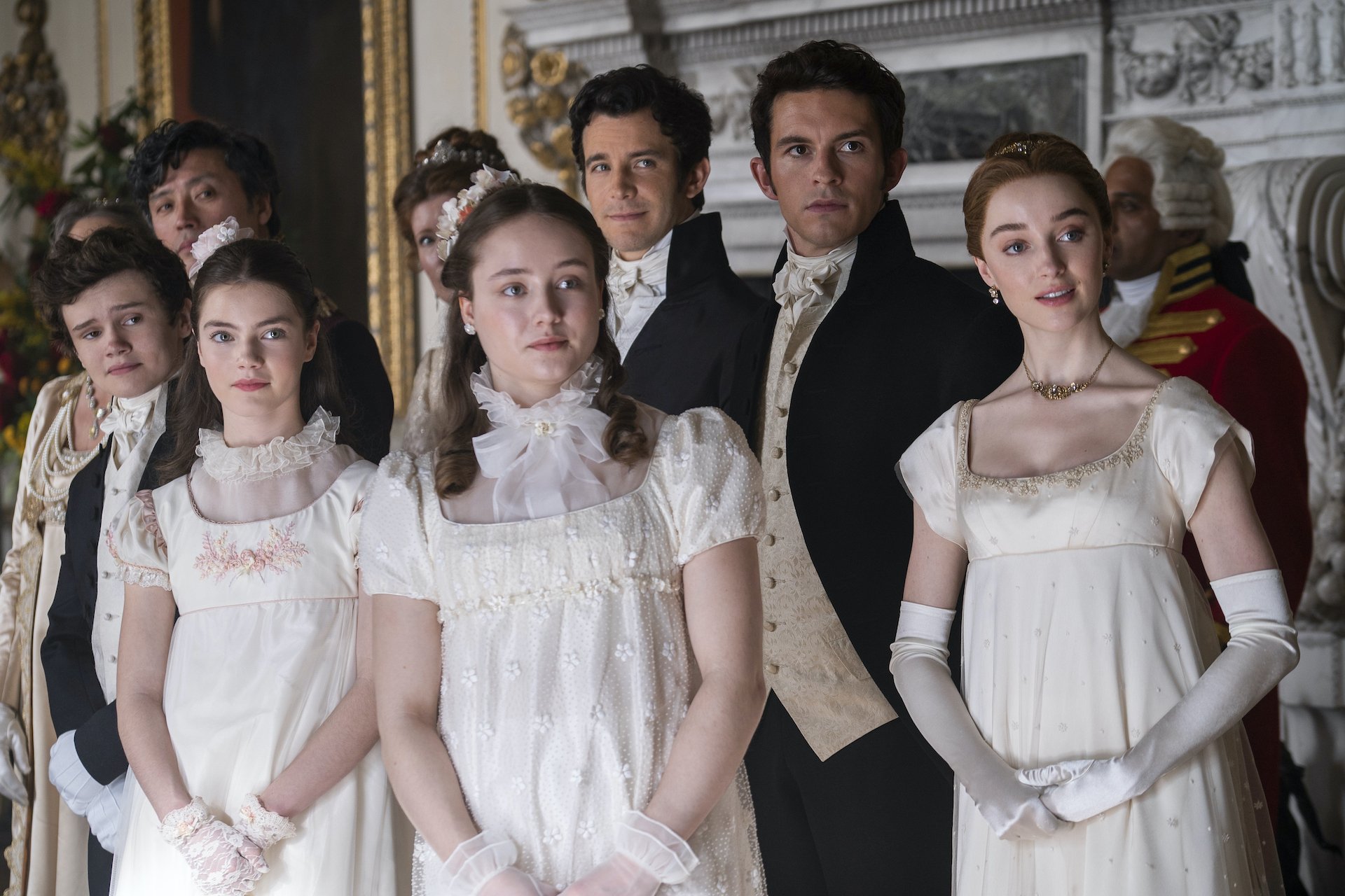 A group of siblings in Regency outfits, looking expectantly out of frame; still from "Bridgerton."