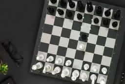 Black and white chessboard with glasses next to it