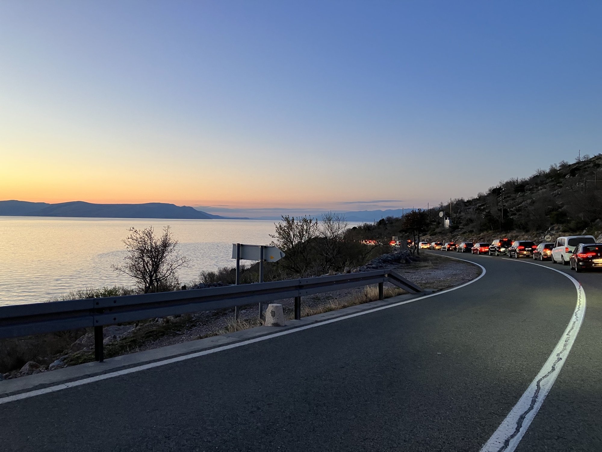 A landscape photo of a seaside highway at sunset taken with an iPhone SE 3.