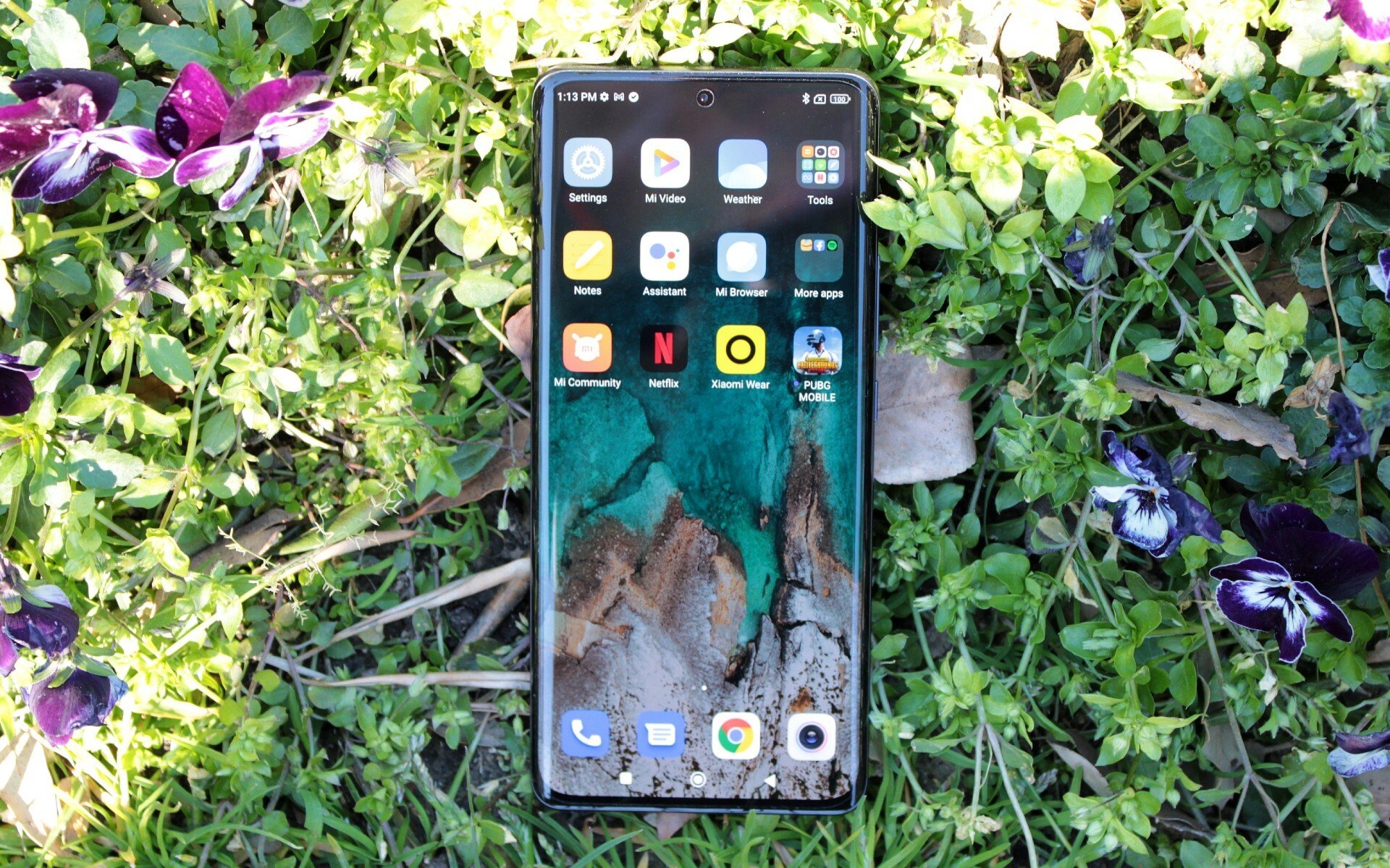 The Xiaomi 12 Pro lying on a flowerbed.