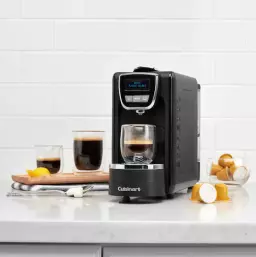 cuisinart espresso machine on a kitchen counter next to cups of espresso