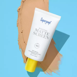 white bottle of suncreen on blue background