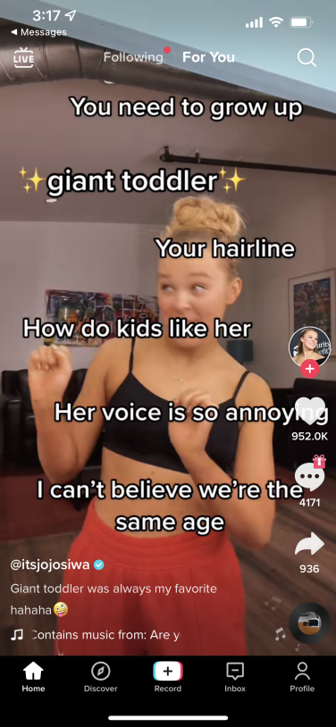 TikTok video showing Jojo Siwa, onscreen text reads "You need to grow up," "giant toddler," "your hairline," "how do kids like her," "her voice is so annoying," and "I can't believe we're the same age".