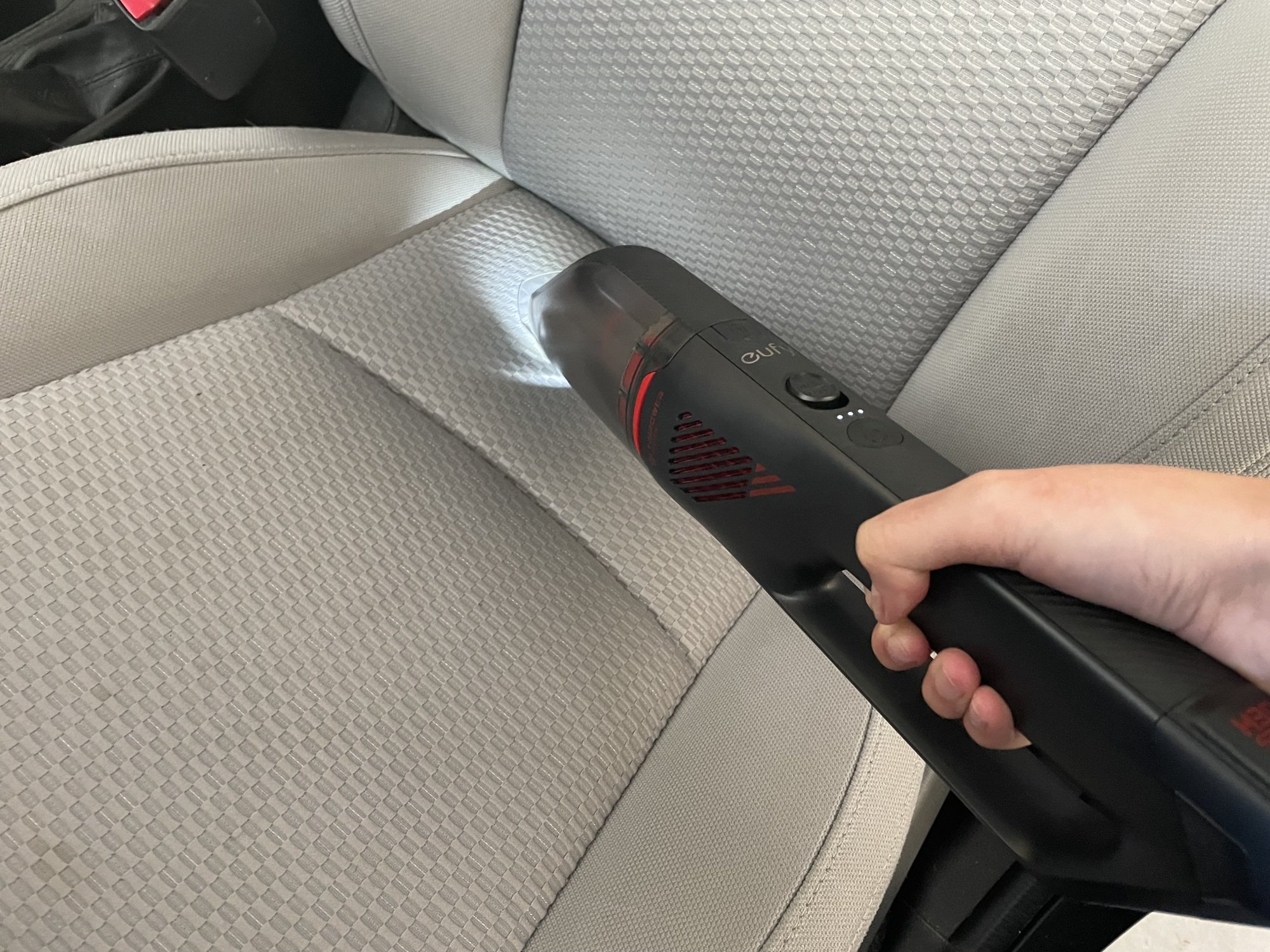 Image of Eufy HomeVac H30 Venture being used on a car seat