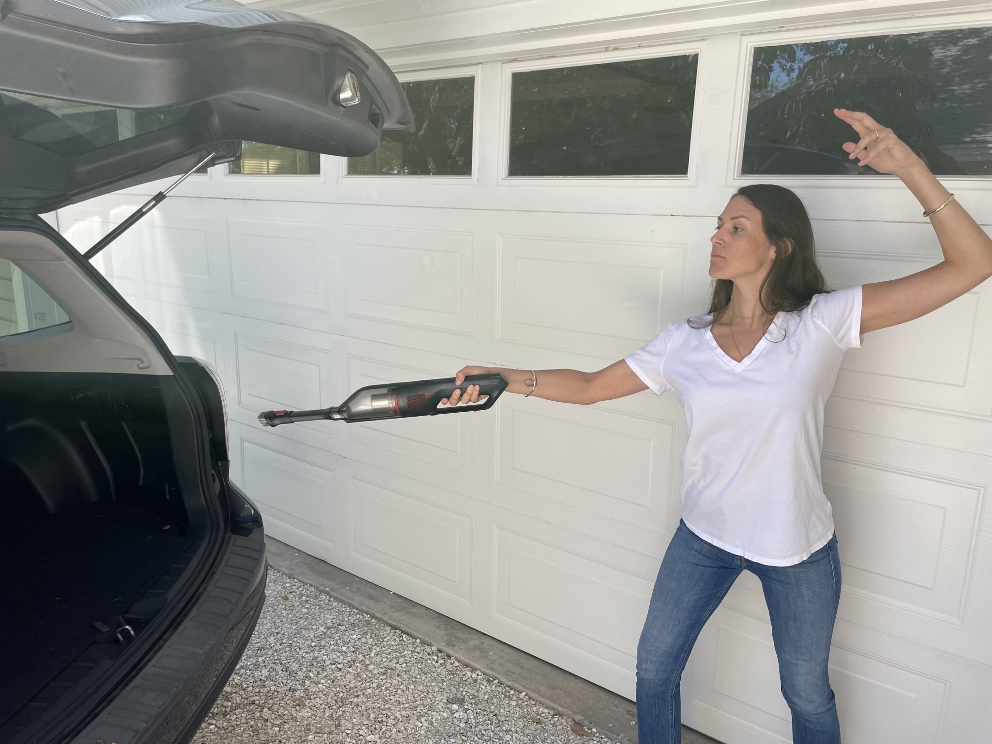 Image of author holding handheld vacuum like a fencing sword