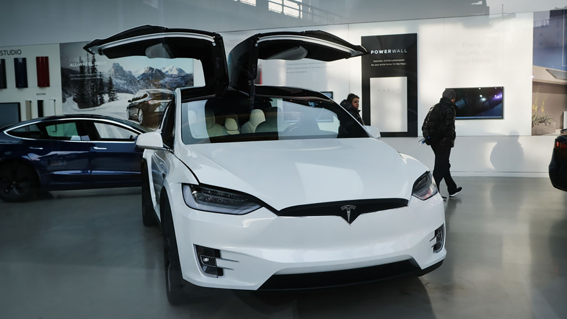 Tesla car in showroom with its doors open.