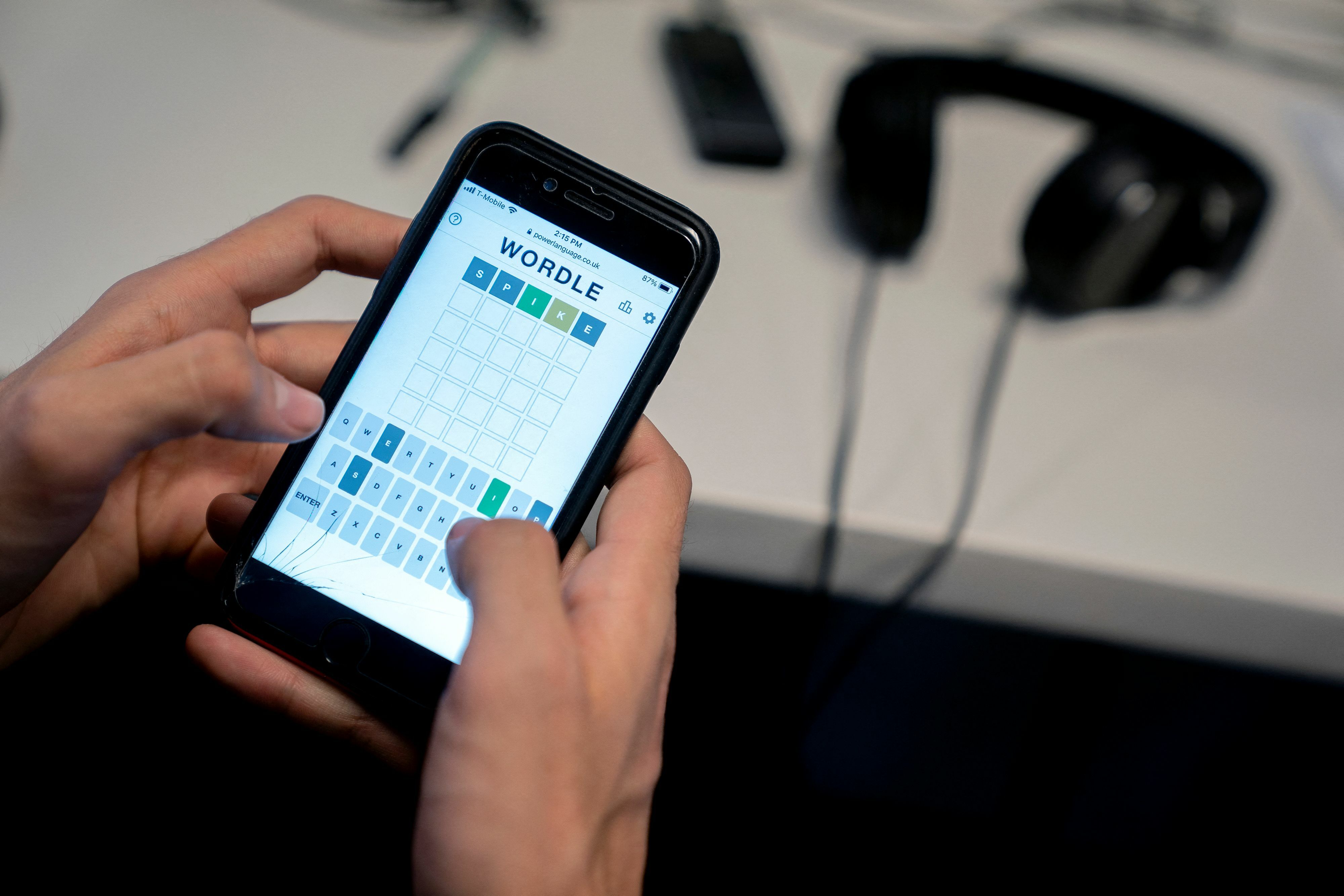 This photo illustration shows a person playing online word game Wordle on a mobile phone. 