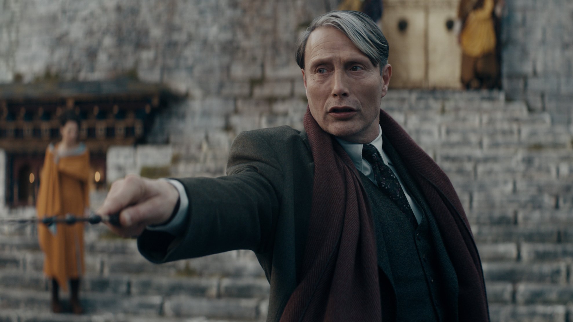 Film still of a man holding a wand.