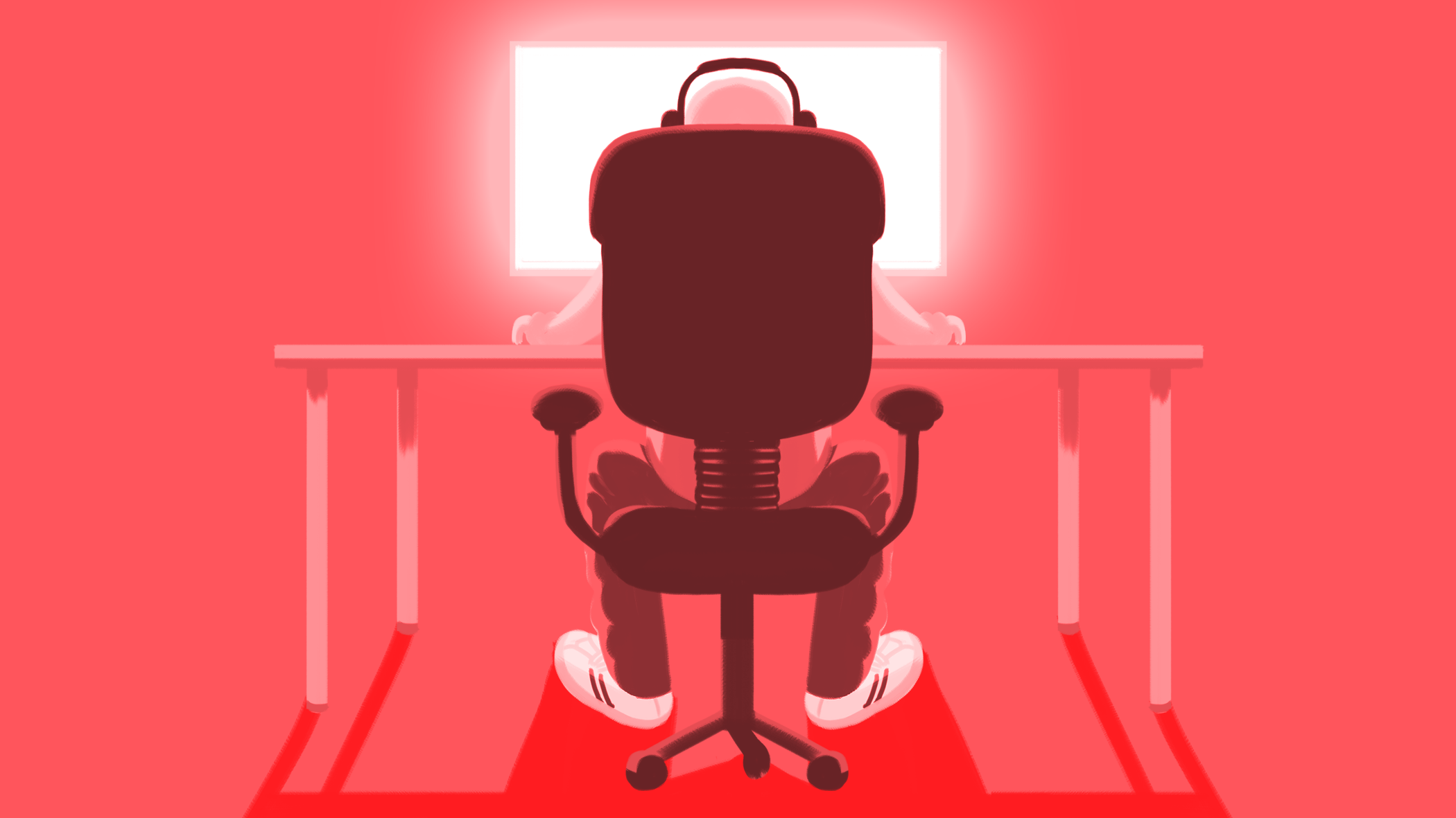 person sits at a desk looking at computer