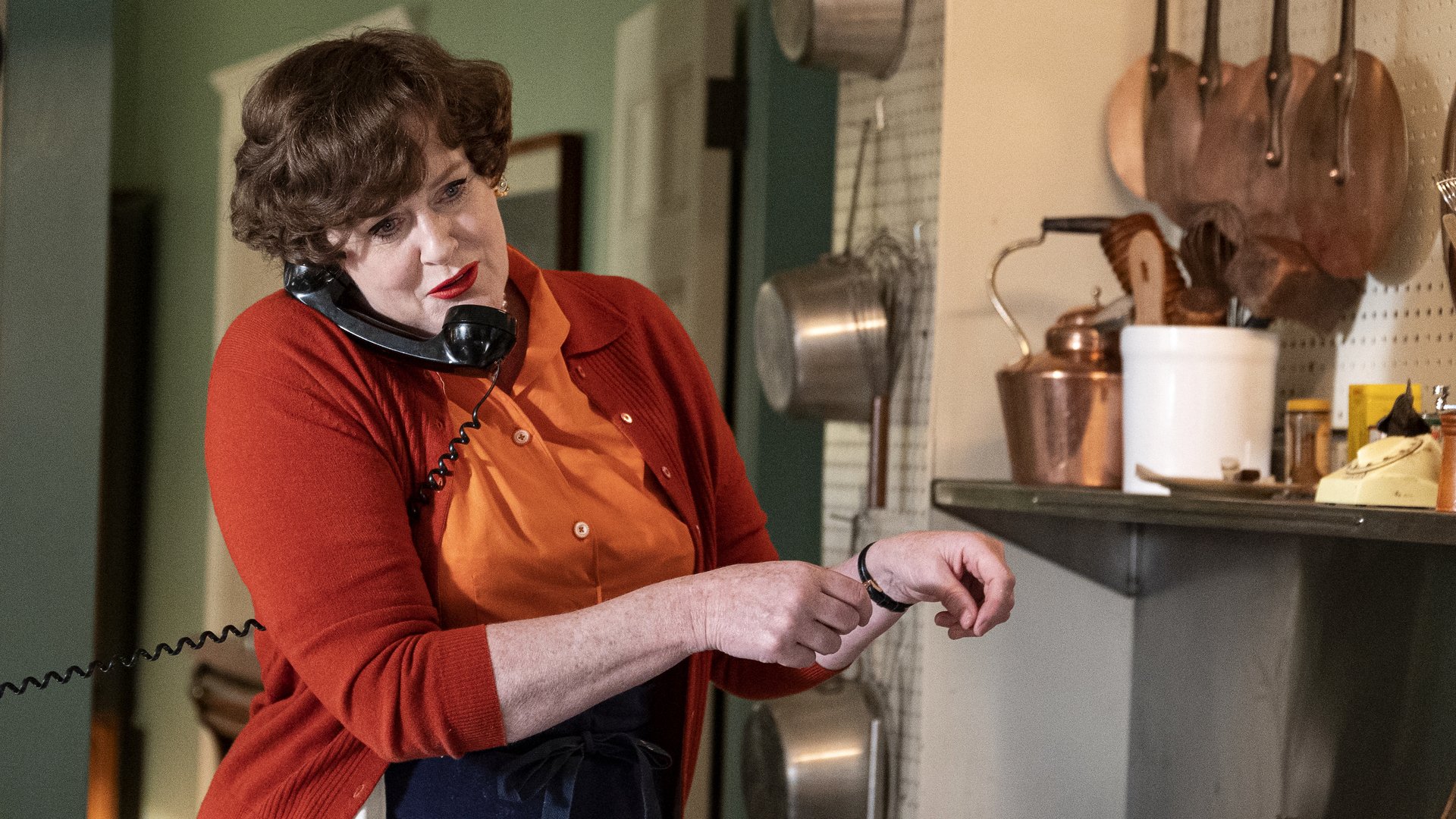 Sarah Lancashire on the phone in her kitchen in "Julia."