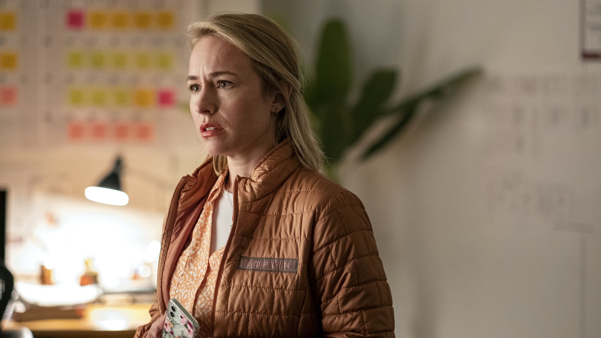 A blonde woman in a tan jacket looks concerned; still from "Barry."