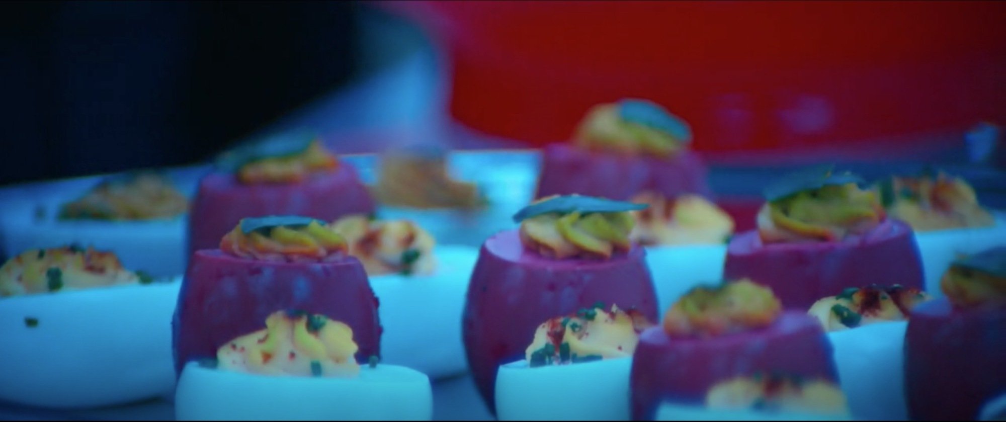 A plate of red and white deviled eggs.
