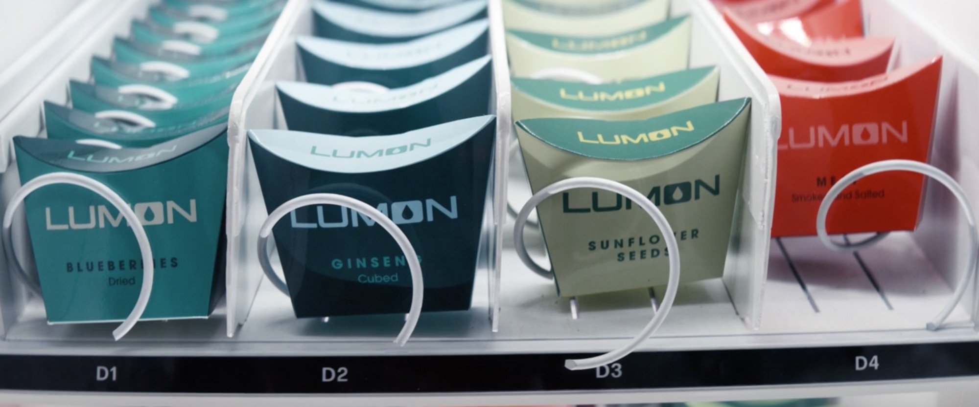 A vending machine row with four snack options: Blueberries, ginseng, sunflower seeds, meat.