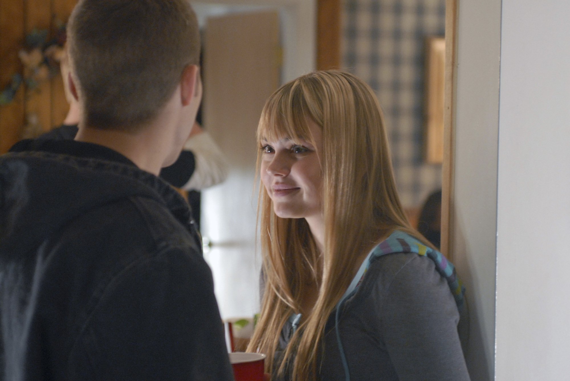 A teenage girl (Aimee Teegarden as Julie Taylor in "FNL") talking to a teenage boy.
