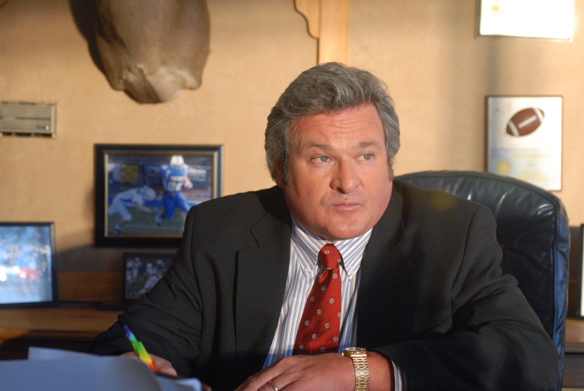 A man (Brad Leland as Buddy Garrity on "FNL") sitting at a desk.