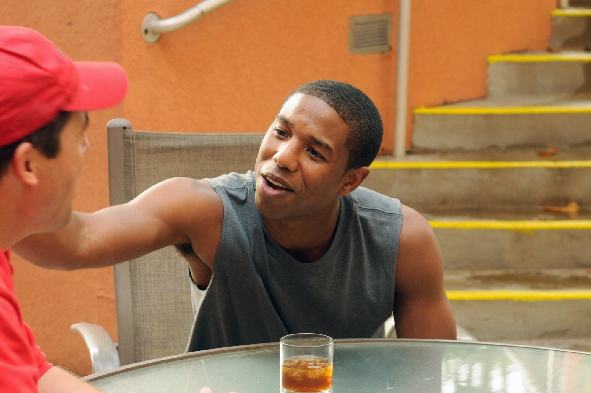 A teenage boy (Michael B. Jordan as Vince on "FNL") holding his football coach's shoulder.