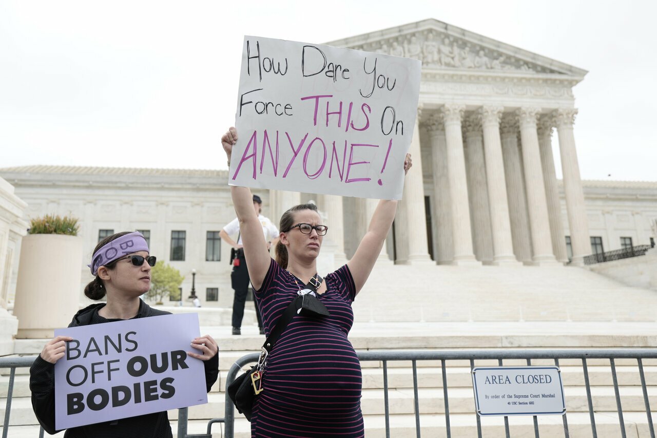A pregnant pro-choice protestor stands in front of the Supreme Court after Roe v Wade leak