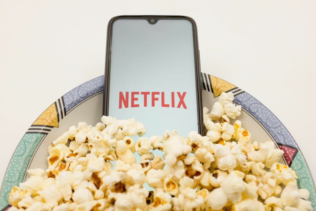 Netflix on phone in bowl of popcorn