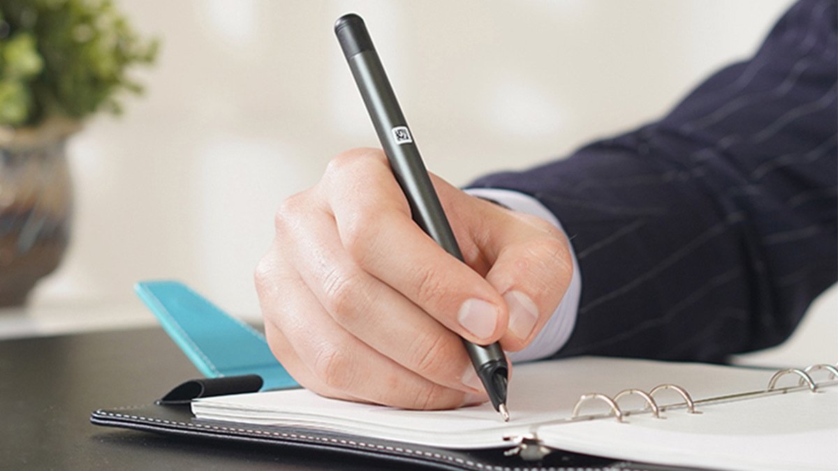 Hand writing on notebook with black stylus pen