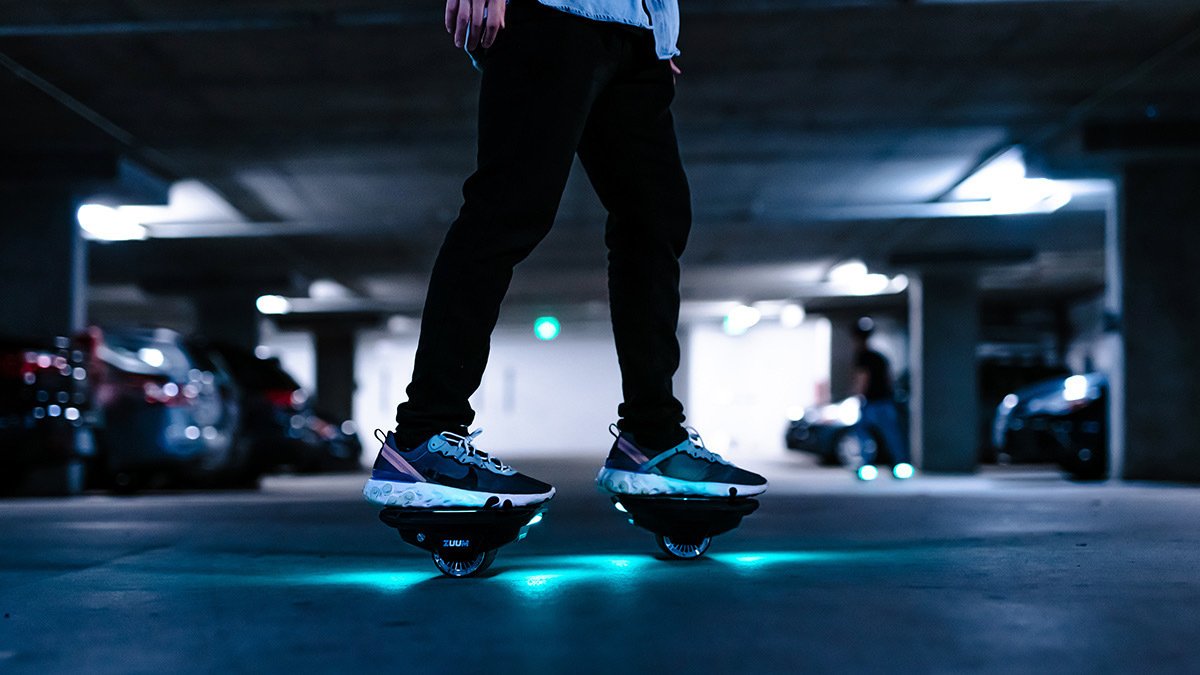 Feet on separate boards with wheels and blue lights