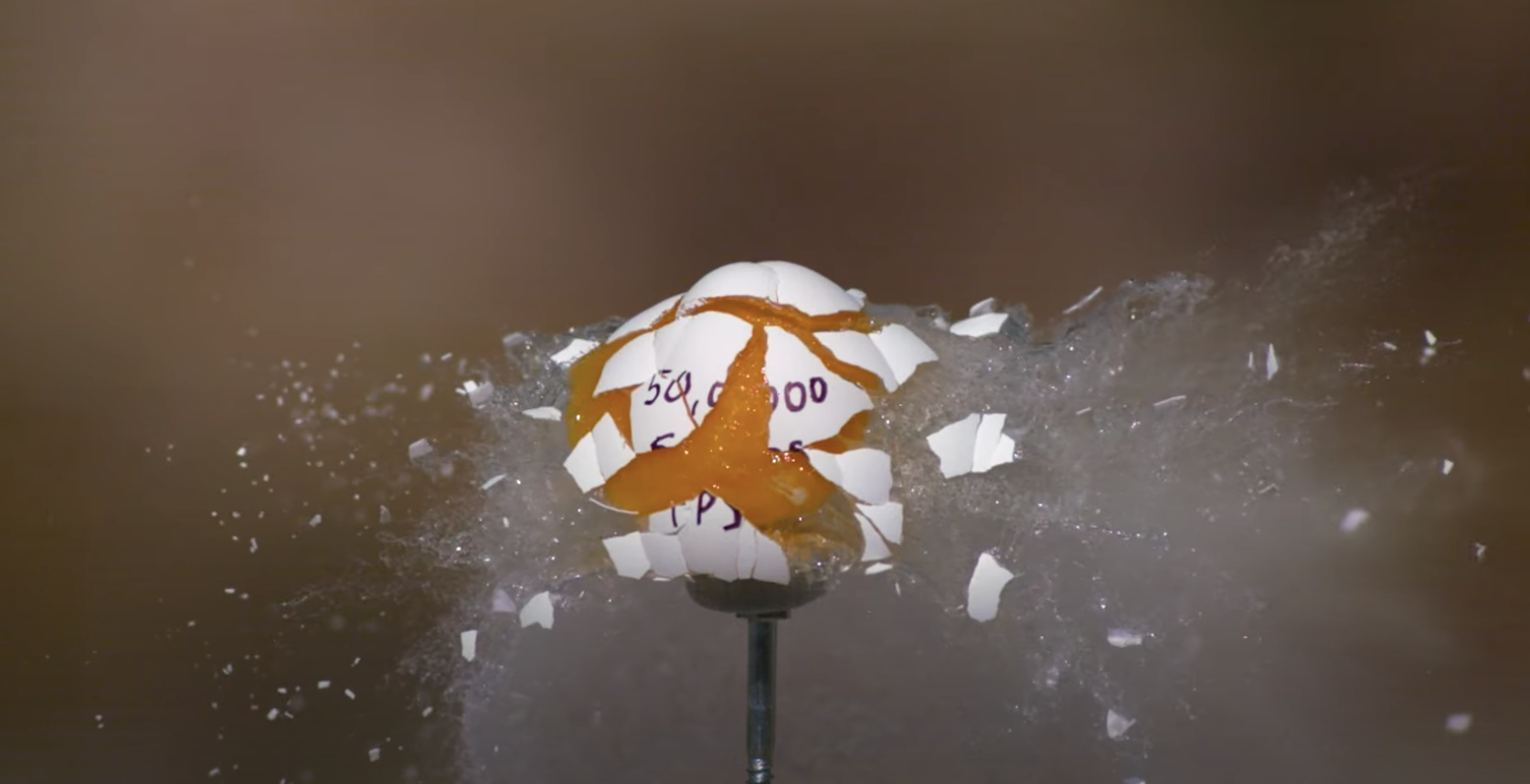 An egg exploding in slow motion, with shell rippling through the air.