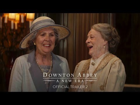 Two older women smile and laugh.