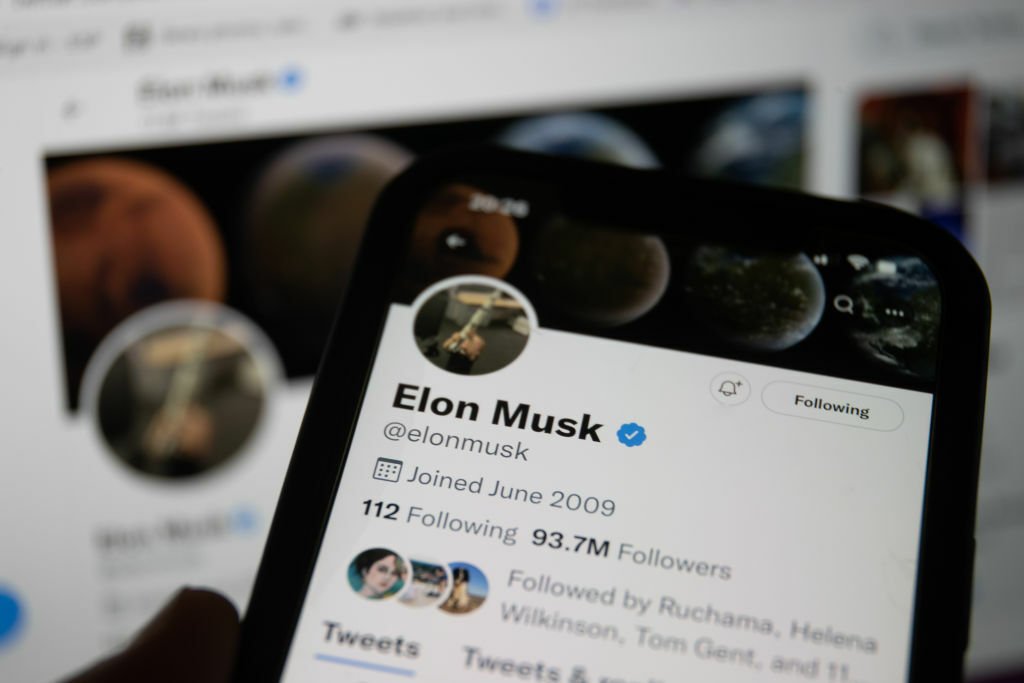 A smartphone showing the Twitter app displaying Elon Musk's Twitter profile.