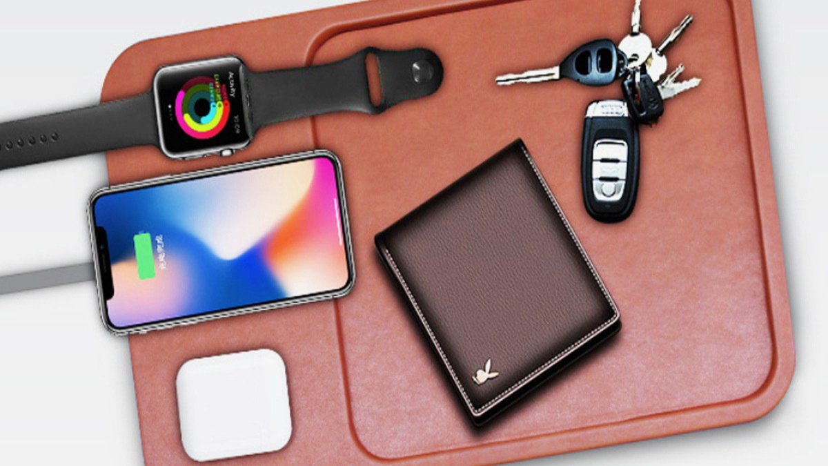 Phone, keys, wallet, airpods, and smartwatch on brown leather pad