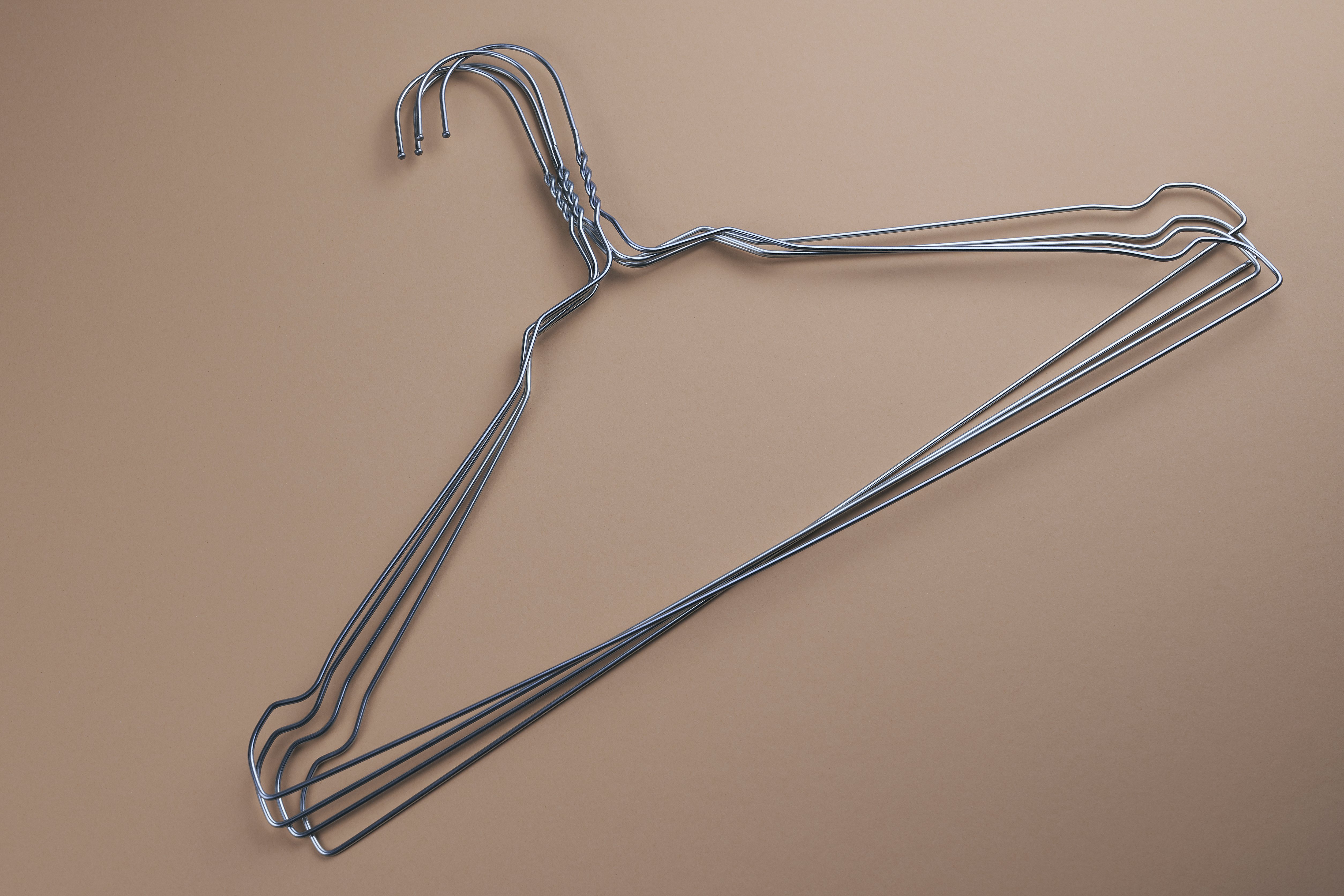 photo of three wire hangers stacked atop each other
