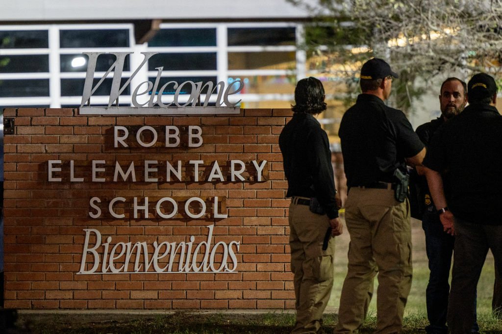 Law enforcement officers speak together outside of Robb Elementary School following the mass shooting at Robb Elementary School on May 24, 2022 in Uvalde, Texas.
