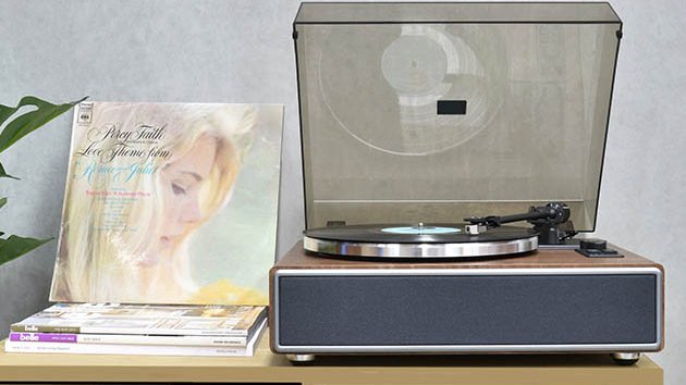 Turntable on shelf next to vinyls