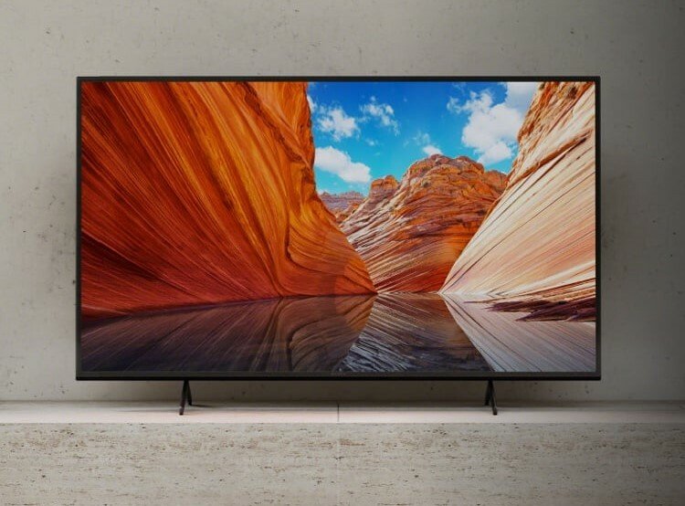Sony X80J 65-inch 4K TV with image of canyons on screen and sitting on shelf