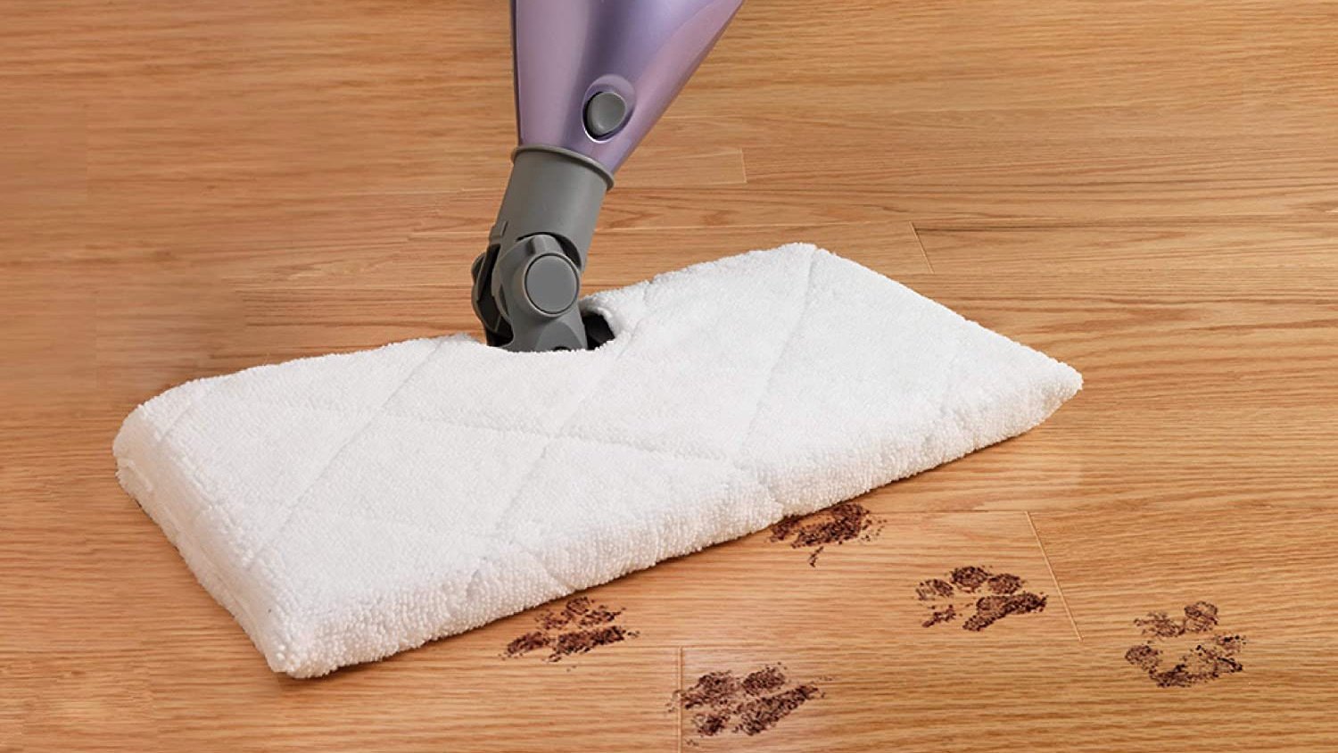 Purple mop with white base cleaning paw tracks from wooden floor