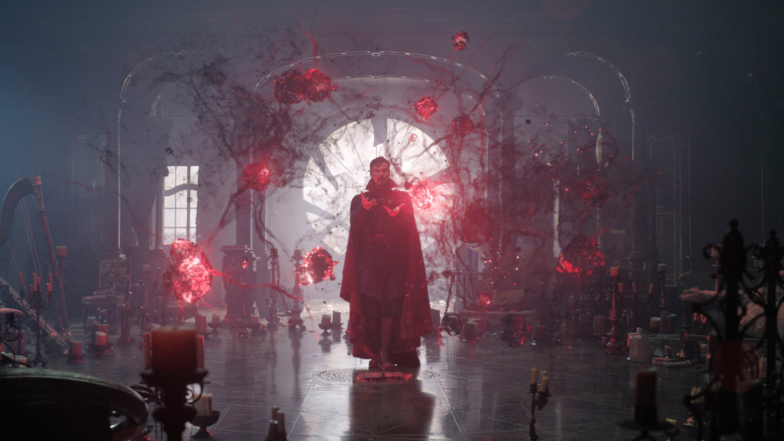 Doctor Strange from the Marvel Cinematic Universe stands in the Sanctum Sanctorum study surrounded by orbs of magical red energy.