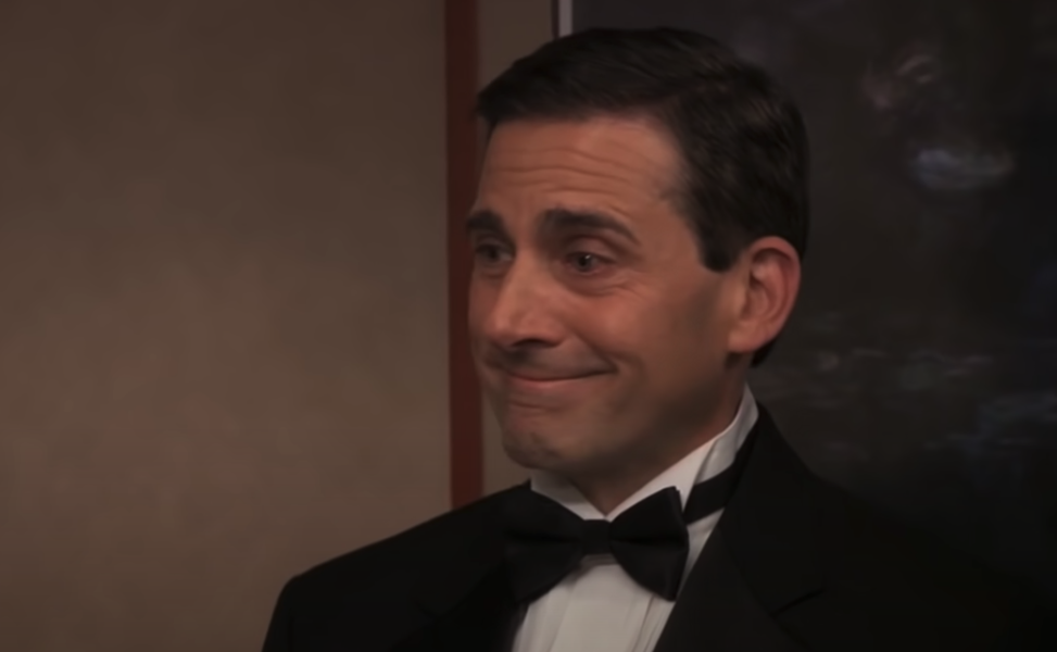A man (Steve Carell) wearing a suit while smiling with tears in his eyes.