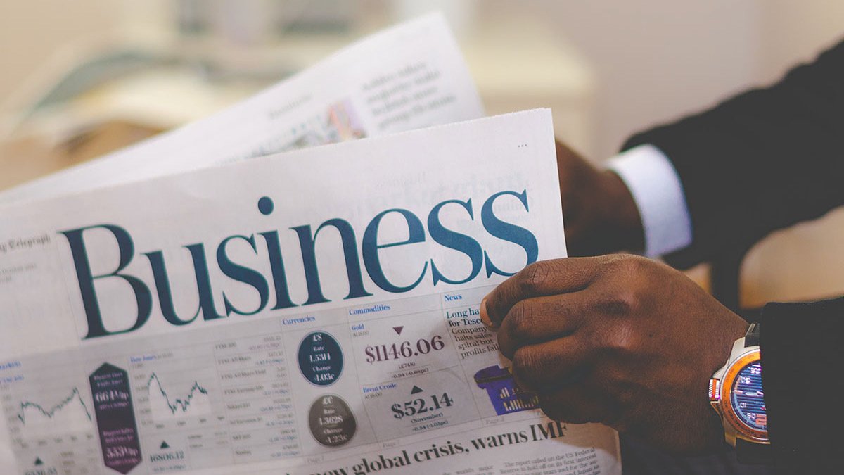 Hands holding business insider newspaper