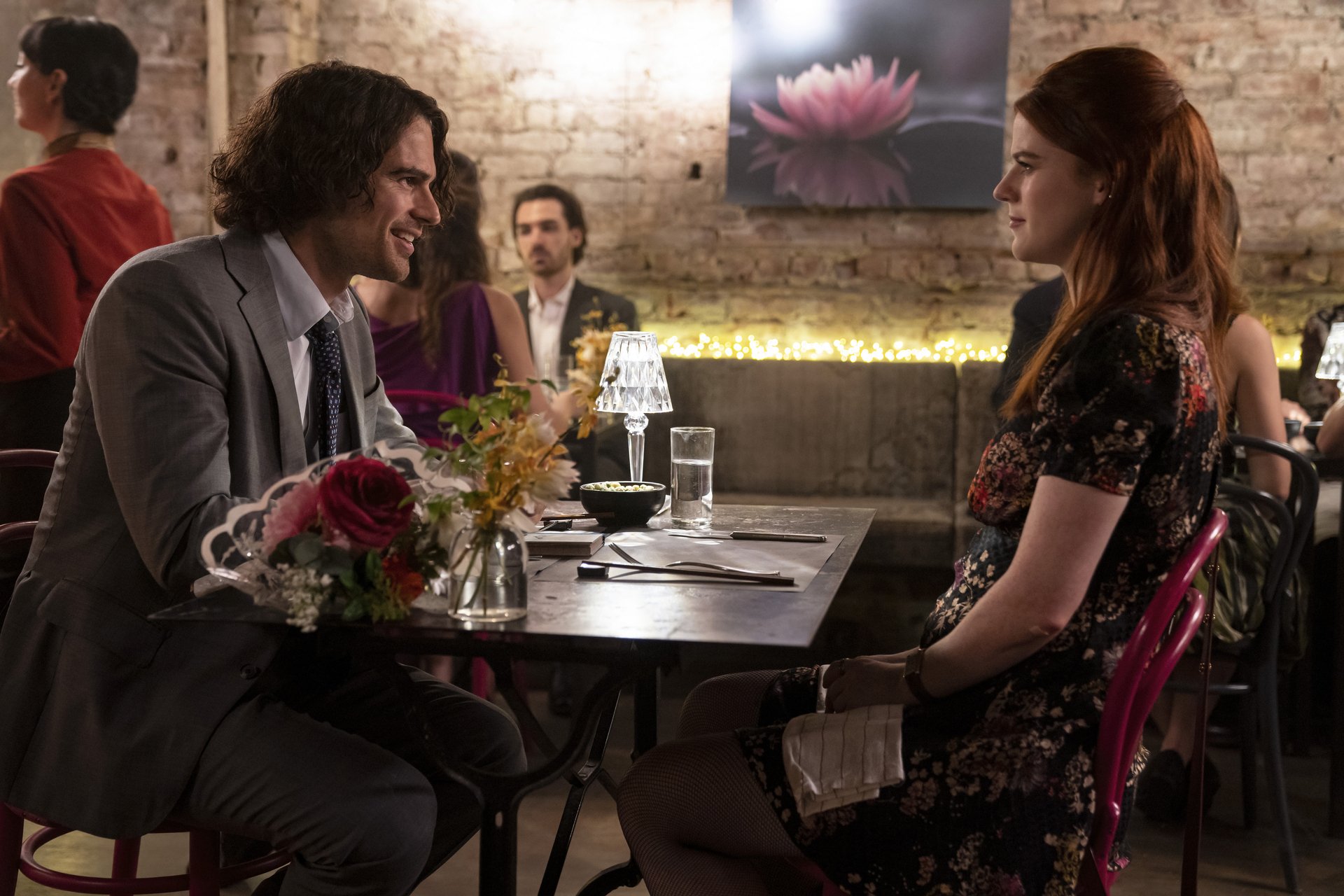 A man and a woman sitting at a table in a restaurant.