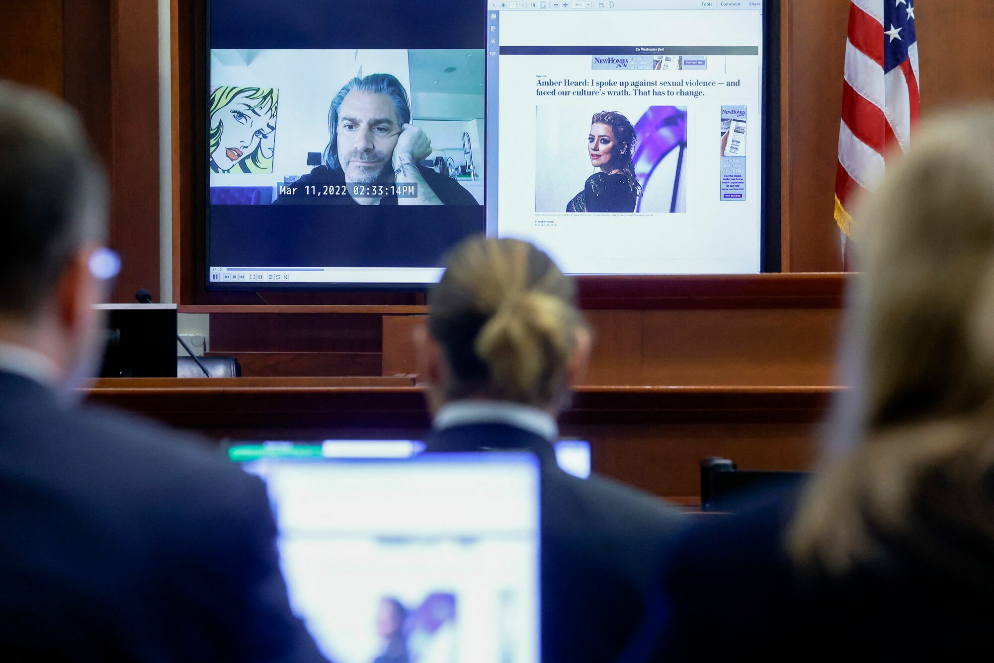 A photo of Christian Carino's taped deposition on a large screen in the court room.