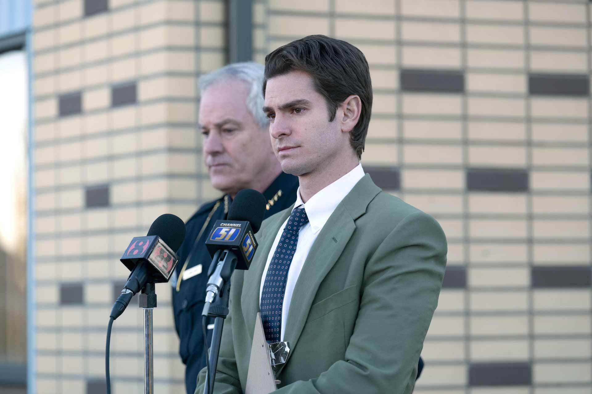 Two men stand at a podium with microphones.
